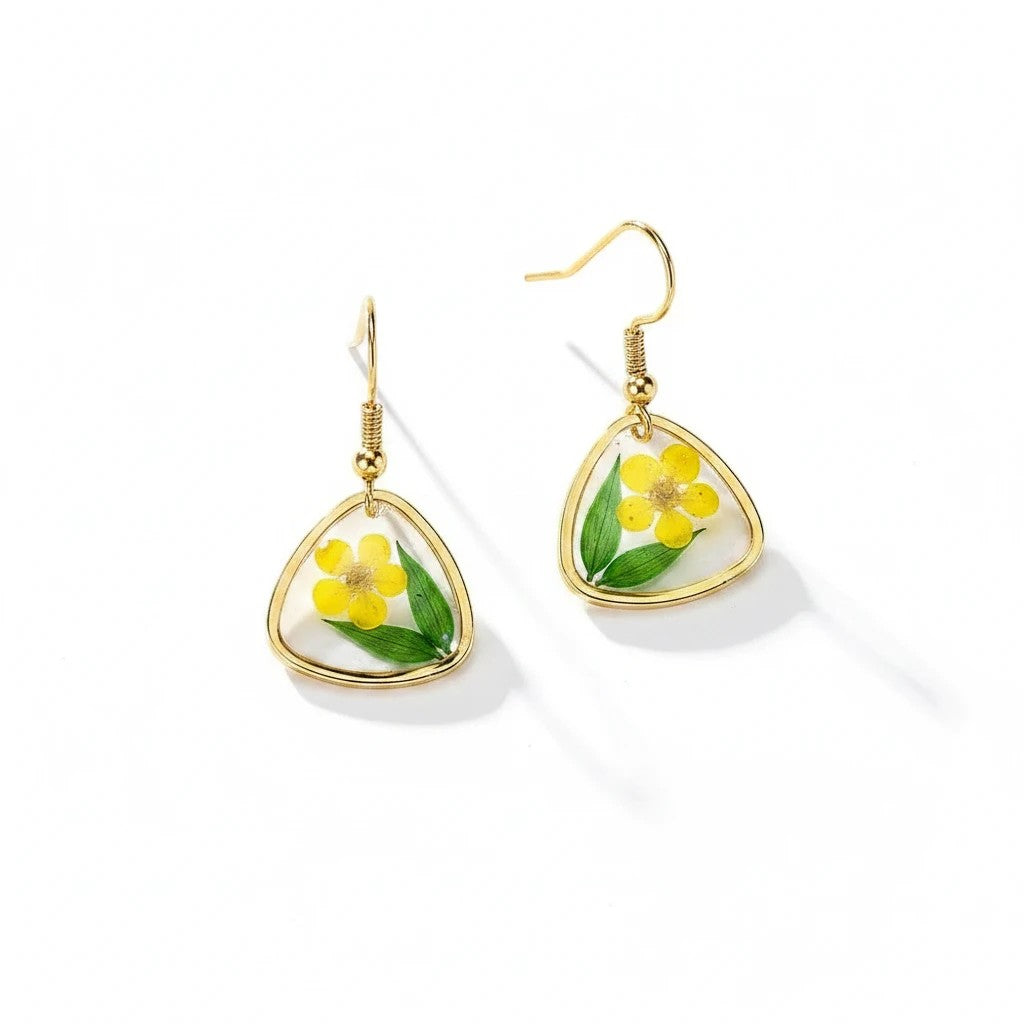 Alyssa's House triangular resin earrings with gold-tone wire, featuring pressed green leaves and yellow flowers.
