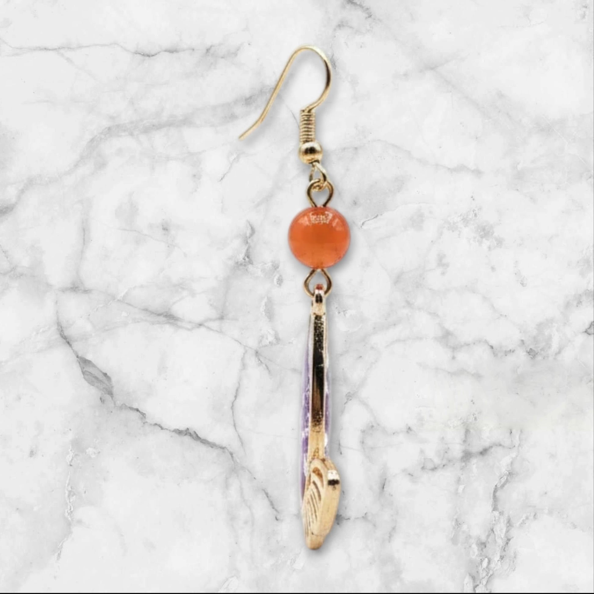 Alyssa's House gold-tone butterfly earrings featuring a purple pressed flower and a red bead accent.
