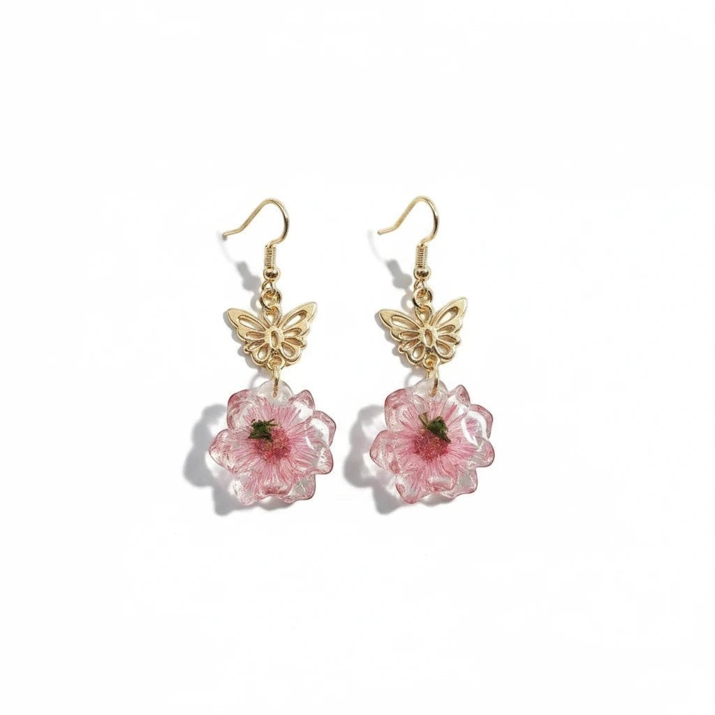 Alyssa's House gold-tone butterfly earrings featuring delicate pink pressed flowers in resin for a feminine style.