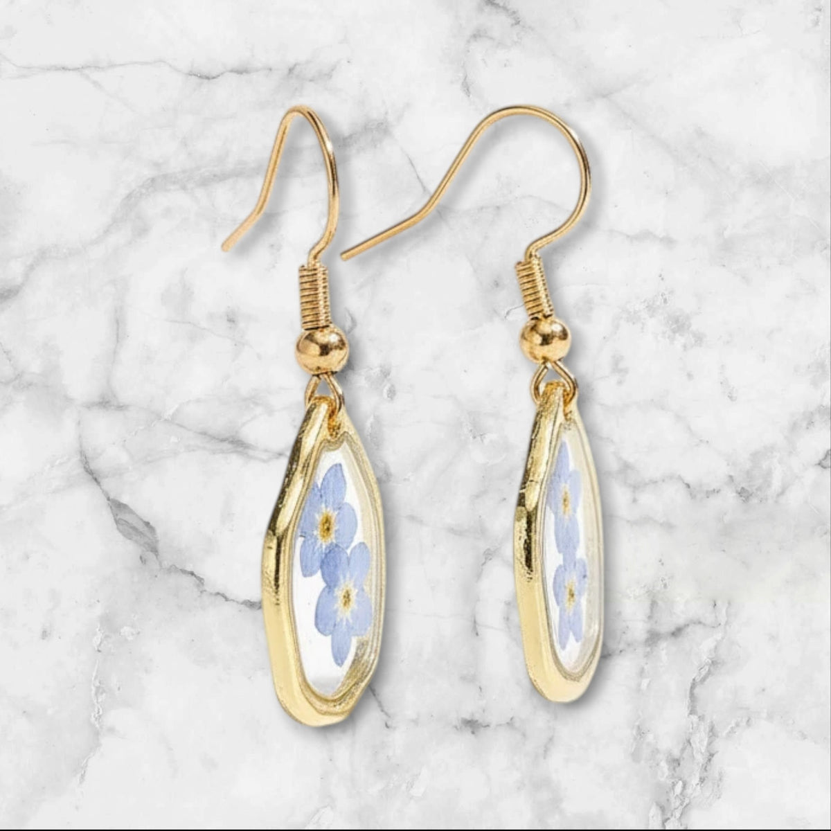 Alyssa's House oval resin earrings featuring blue forget-me-not flowers in a gold-tone frame for everyday wear.