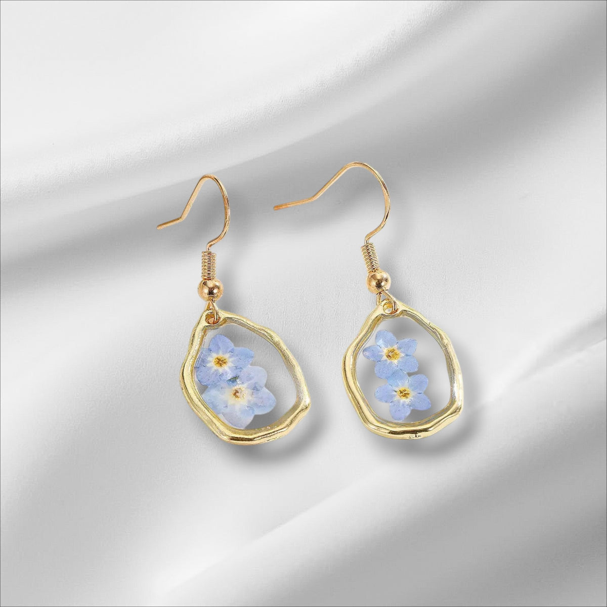Alyssa's House oval resin earrings featuring blue forget-me-not flowers in a gold-tone frame for everyday wear.