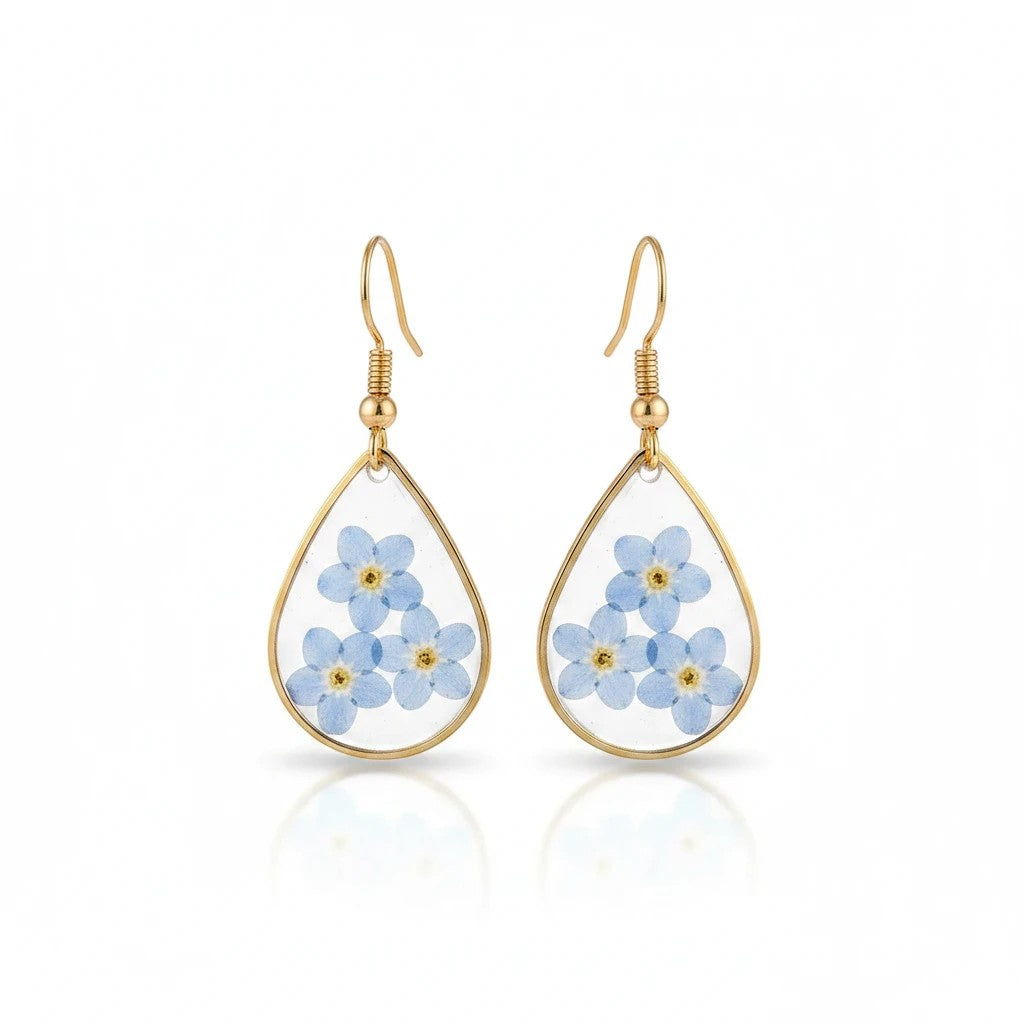 Alyssa's House teardrop resin earrings featuring real blue forget-me-not flowers encased in gold-tone wire frames.