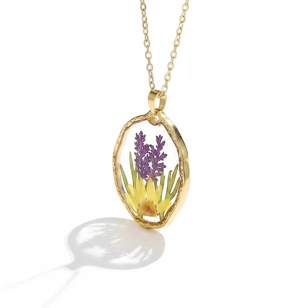 Alyssa's House gold pendant necklace featuring preserved lavender and yellow flowers in clear resin on a delicate chain.