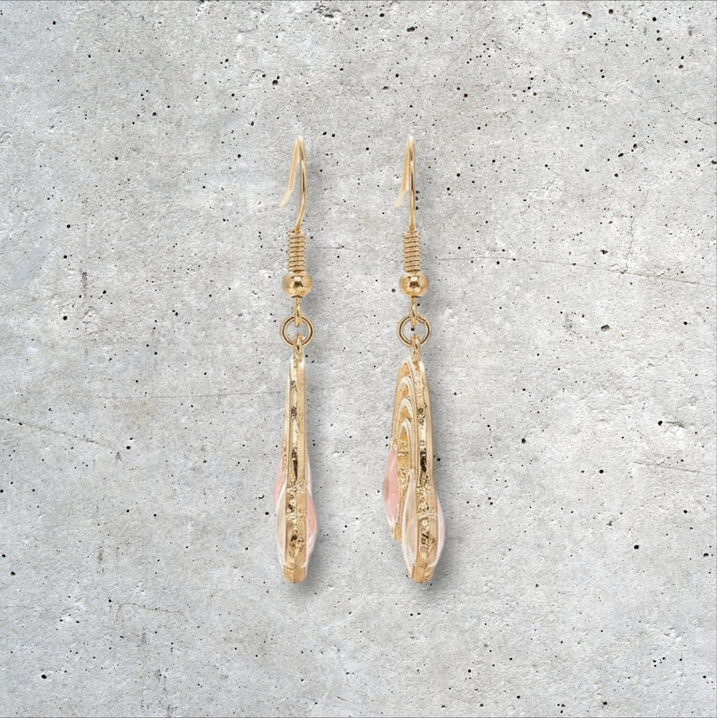 Alyssa's House gold-tone rainbow earrings featuring pressed flowers and pearl accents for a cheerful statement look.