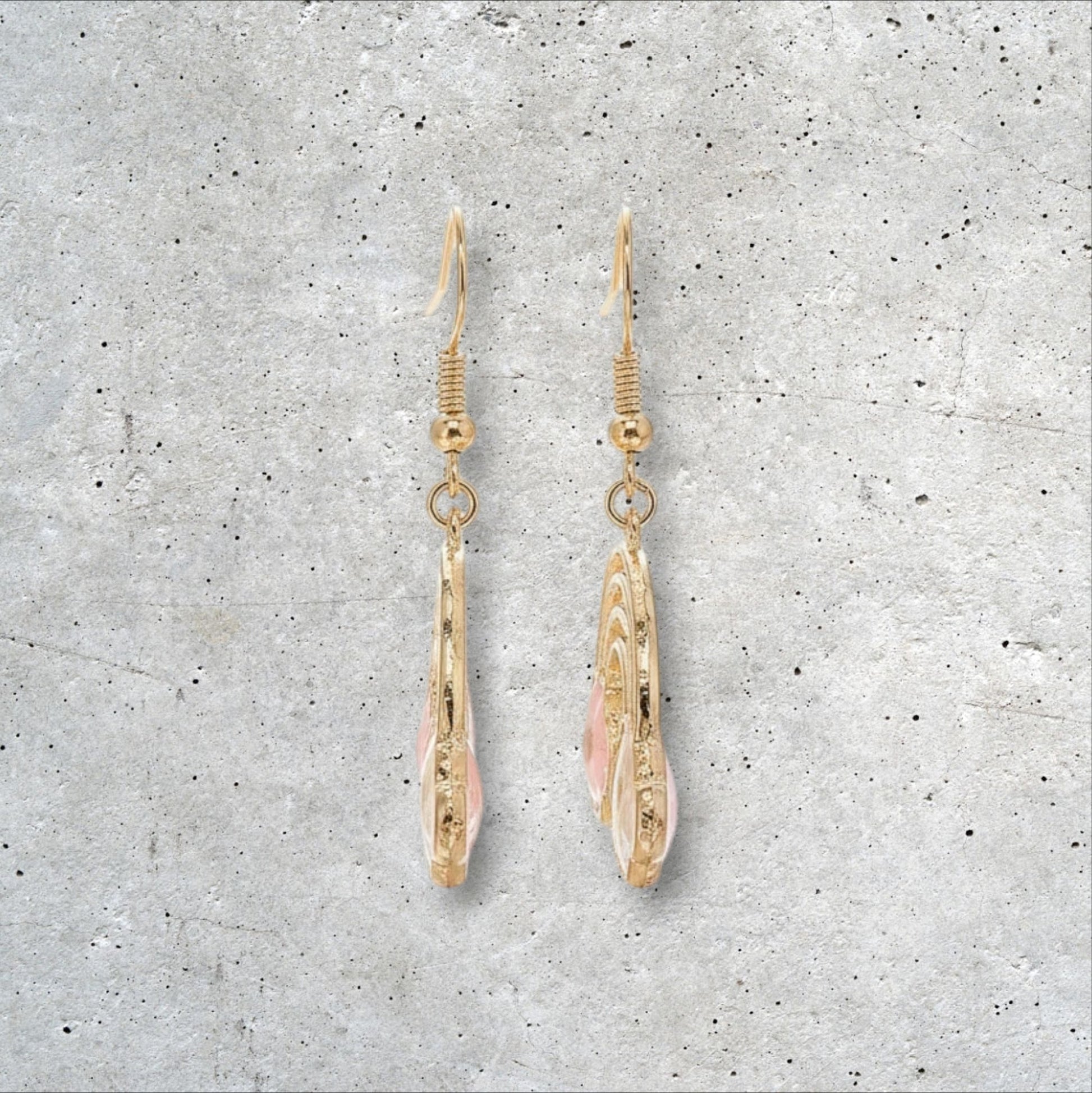 Alyssa's House gold-tone rainbow earrings featuring pressed flowers and pearl accents for a cheerful statement look.
