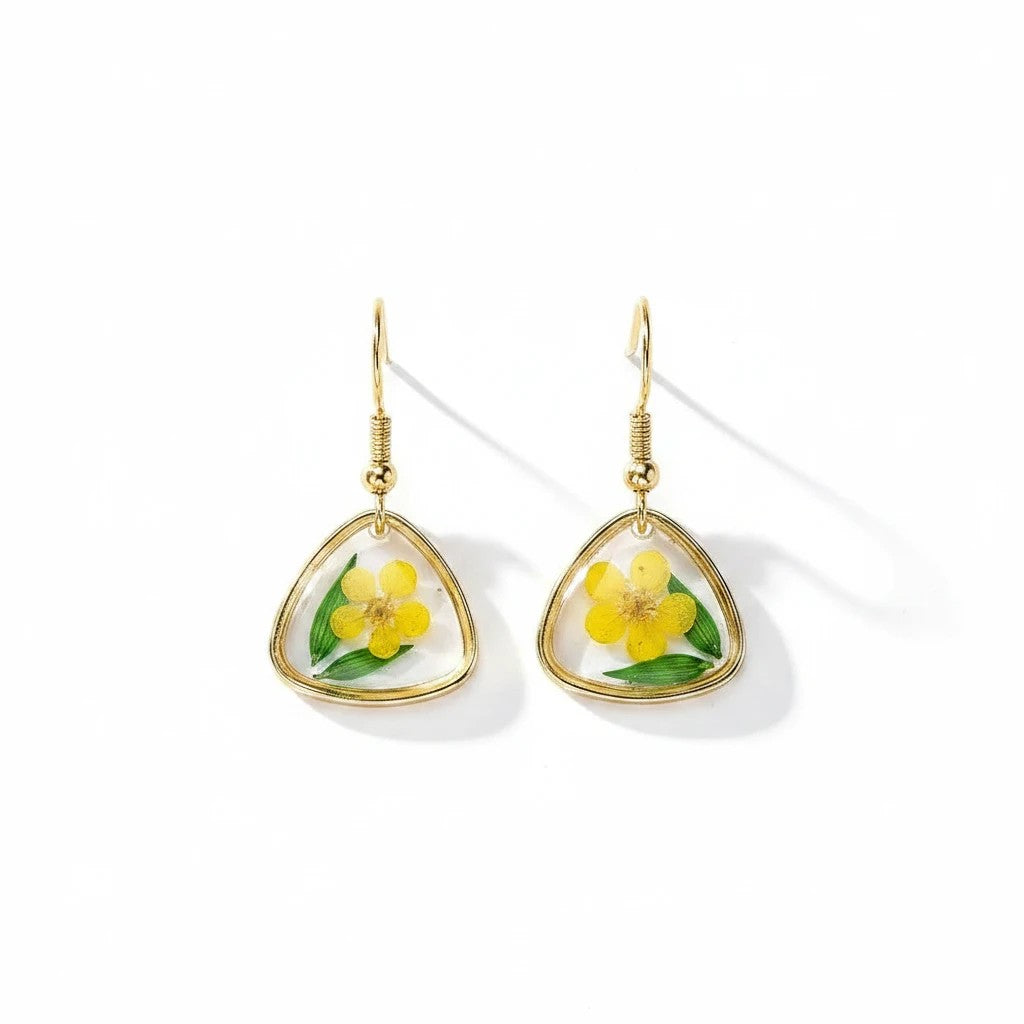 Alyssa's House triangle resin earrings with gold-tone wire, featuring pressed green leaves and yellow flowers.