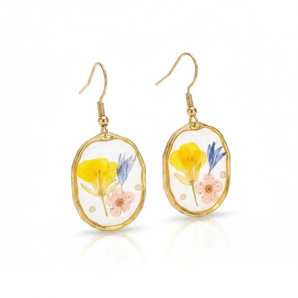 Alyssa's House oval resin drop earrings featuring pressed yellow and blue wildflowers inside a gold-tone rim.